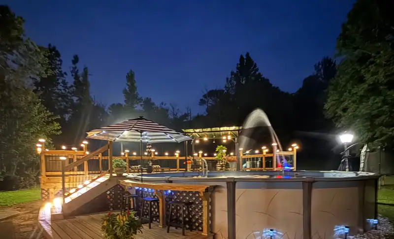 A lit pool deck at night, built by Alabama Quality Restoration
