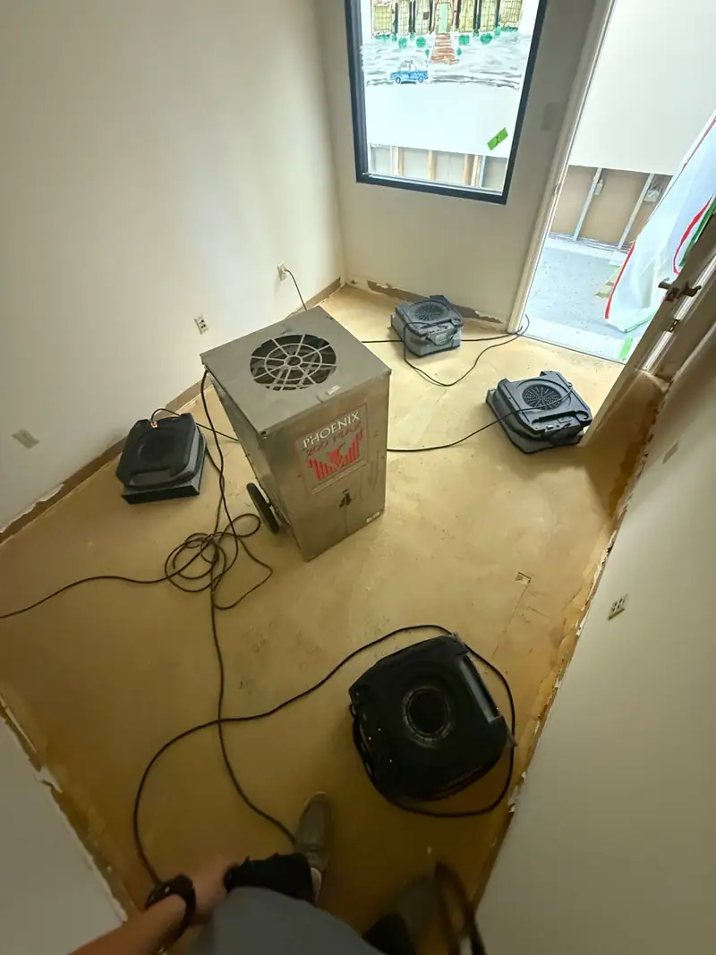 Air scrubber and air movers running in a small room on bare subfloor